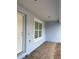 Exterior features light blue stucco with white trim, a window, and front door at 13075 Se 35Th Ct, Belleview, FL 34420