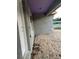 Close-up of stucco and wood trim details on the front exterior at 13075 Se 35Th Ct, Belleview, FL 34420