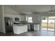 Modern kitchen boasts stainless appliances, a center island, and sliding glass doors leading to the backyard at 13075 Se 35Th Ct, Belleview, FL 34420