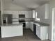 Modern kitchen features stainless steel appliances, granite countertops and kitchen island at 13075 Se 35Th Ct, Belleview, FL 34420
