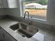 Stainless steel kitchen sink with granite countertops and a window view at 13075 Se 35Th Ct, Belleview, FL 34420