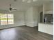 Open-concept living area with lots of natural light and modern ceiling fan at 13075 Se 35Th Ct, Belleview, FL 34420