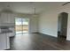 Open-concept living area has recessed lighting and access to the backyard via glass doors at 13075 Se 35Th Ct, Belleview, FL 34420