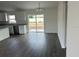 Living room with wood floors and sliding glass doors to backyard at 13075 Se 35Th Ct, Belleview, FL 34420