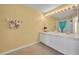 Bathroom with double vanity, a large mirror, and a shower/tub at 1541 Florentino Ln, Winter Park, FL 32792