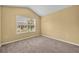 Bedroom with window and tan carpet at 1541 Florentino Ln, Winter Park, FL 32792