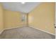 Comfortable bedroom featuring neutral carpet, a window, and soft yellow walls at 1541 Florentino Ln, Winter Park, FL 32792
