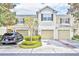 Charming townhome with a well-manicured lawn and attached garages in a desirable neighborhood at 1541 Florentino Ln, Winter Park, FL 32792