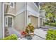 Charming townhome showcasing well-maintained landscaping, an attached garage, and a covered front entrance at 1541 Florentino Ln, Winter Park, FL 32792