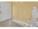 Bright foyer with neutral tile flooring, white door and trim, and a visible staircase at 1541 Florentino Ln, Winter Park, FL 32792