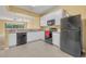 Bright kitchen features white cabinets, a tile floor, and black appliances at 1541 Florentino Ln, Winter Park, FL 32792
