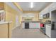 Well-lit kitchen featuring modern black appliances, crisp white cabinets, and open design at 1541 Florentino Ln, Winter Park, FL 32792