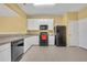 Bright kitchen features white cabinets, a tile floor, and modern appliances at 1541 Florentino Ln, Winter Park, FL 32792