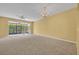 Bright living room with carpet, ceiling fan, chandelier and sliding glass doors to the outdoors at 1541 Florentino Ln, Winter Park, FL 32792