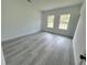 Bedroom with two windows provides ample natural light and neutral gray flooring at 16697 Sw 23Rd Avenue Rd, Ocala, FL 34473
