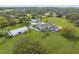 Aerial view of estate home with multiple structures and large grassy property at 17726 Dangler Rd, Winter Garden, FL 34787