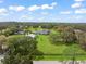 Expansive aerial view showcases a sprawling estate with lush greenery, mature trees, and a stunning main residence at 17726 Dangler Rd, Winter Garden, FL 34787