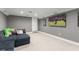 A finished basement with plush carpet and a large television at 17726 Dangler Rd, Winter Garden, FL 34787