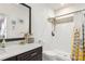 Bathroom featuring white herringbone tile shower and dark cabinets with white countertop at 17726 Dangler Rd, Winter Garden, FL 34787