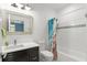 A bright bathroom with a white tiled shower and a granite vanity at 17726 Dangler Rd, Winter Garden, FL 34787