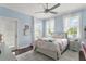 Cozy bedroom with hardwood floors, windows with white curtains and a ceiling fan at 17726 Dangler Rd, Winter Garden, FL 34787