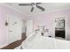 A light purple bedroom with hard wood floors and a desk and vanity at 17726 Dangler Rd, Winter Garden, FL 34787