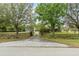 Long, private driveway leading to a secluded estate, surrounded by mature trees and manicured landscaping at 17726 Dangler Rd, Winter Garden, FL 34787