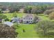 Expansive two-story home with a screened pool and sprawling green lawn at 17726 Dangler Rd, Winter Garden, FL 34787