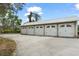 A detached garage with four doors and gray concrete at 17726 Dangler Rd, Winter Garden, FL 34787