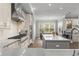 A bright kitchen with an island, stainless steel appliances, and an adjacent dining area near large windows at 17726 Dangler Rd, Winter Garden, FL 34787