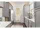 Grey kitchen featuring a stainless steel refrigerator, white countertops and access to exterior at 17726 Dangler Rd, Winter Garden, FL 34787