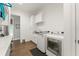 Bright laundry room with modern washer, dryer, sink, and ample storage at 17726 Dangler Rd, Winter Garden, FL 34787