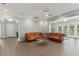 Large living room featuring a sectional sofa, ceiling fan, and glass table at 17726 Dangler Rd, Winter Garden, FL 34787