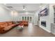 Spacious living room with sectional sofa, TV, ceiling fan, and patio access at 17726 Dangler Rd, Winter Garden, FL 34787