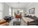 Sitting room featuring a piano, daybed, ottoman, leather chair, and patterned rug at 17726 Dangler Rd, Winter Garden, FL 34787