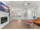 Open-concept living room with fireplace, built-ins, and wood-look tile flooring at 17726 Dangler Rd, Winter Garden, FL 34787