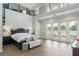 Bright main bedroom with tile floors, black iron railing, and floor to ceiling windows at 17726 Dangler Rd, Winter Garden, FL 34787