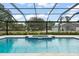 A beautiful screened-in pool with spa, surrounded by lush landscaping, offers a relaxing outdoor retreat at 17726 Dangler Rd, Winter Garden, FL 34787