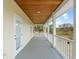A covered porch with white columns under a wood ceiling stretches along the side of the home at 17726 Dangler Rd, Winter Garden, FL 34787