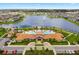 An aerial view of a community pool and playground next to a lake at 2200 Rapollo Dr, Kissimmee, FL 34741