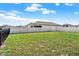 Large backyard with a well-kept lawn and a sturdy white fence at 2200 Rapollo Dr, Kissimmee, FL 34741