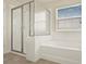 Bright bathroom featuring a large tub and a glass door shower at 2200 Rapollo Dr, Kissimmee, FL 34741