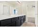 Bathroom with dual vanities, dark wood cabinets, and tile flooring at 2200 Rapollo Dr, Kissimmee, FL 34741