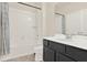 Well-lit bathroom features a shower and bathtub combination with a black vanity at 2200 Rapollo Dr, Kissimmee, FL 34741