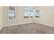 Carpeted bedroom featuring bright natural light coming from large windows at 2200 Rapollo Dr, Kissimmee, FL 34741