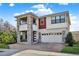 Two-story home boasting a contemporary design, with stone accents and a brick-paved driveway at 2200 Rapollo Dr, Kissimmee, FL 34741