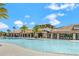 Exterior view of community pool with a shallow entry and palm trees at 2200 Rapollo Dr, Kissimmee, FL 34741