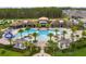 Aerial view of large community pool with palm trees, pergolas and a splash pad at 2200 Rapollo Dr, Kissimmee, FL 34741