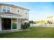Spacious backyard features a patio, green lawn, and white picket fence at 2260 Rapollo Dr, Kissimmee, FL 34741