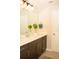 Bathroom featuring a vanity with a white countertop, decorative plants, and a large mirror at 2260 Rapollo Dr, Kissimmee, FL 34741